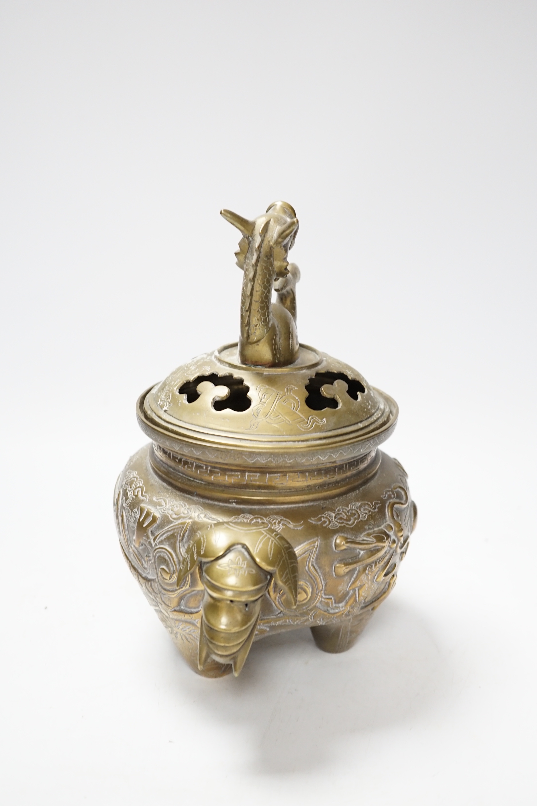 A Chinese bronze ‘dragon’ tripod censer and cover, 24cm